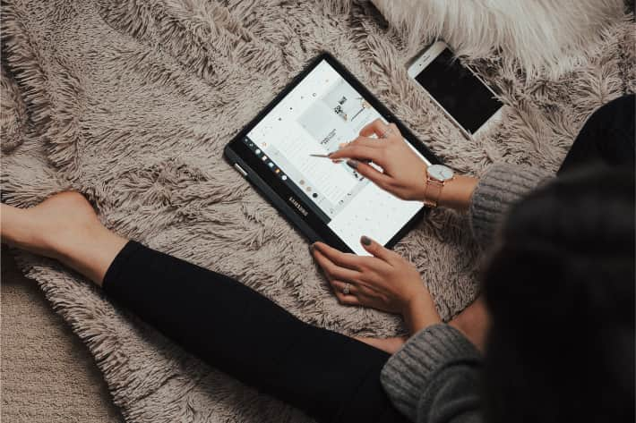 Woman browsing Samsung tablet with pen